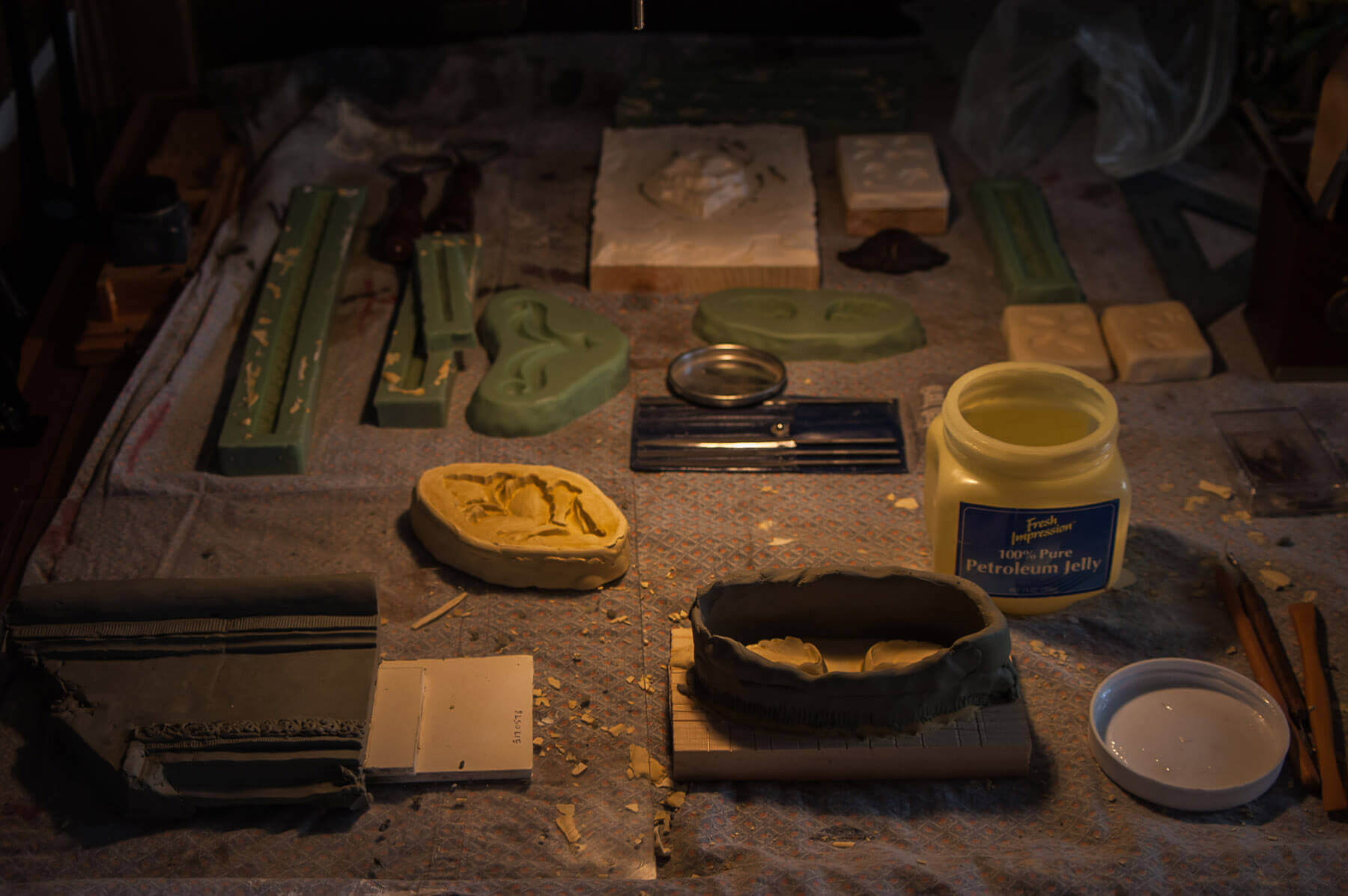 In the foreground of this photograph, molds are ready to be poured for large leaves that are part of...