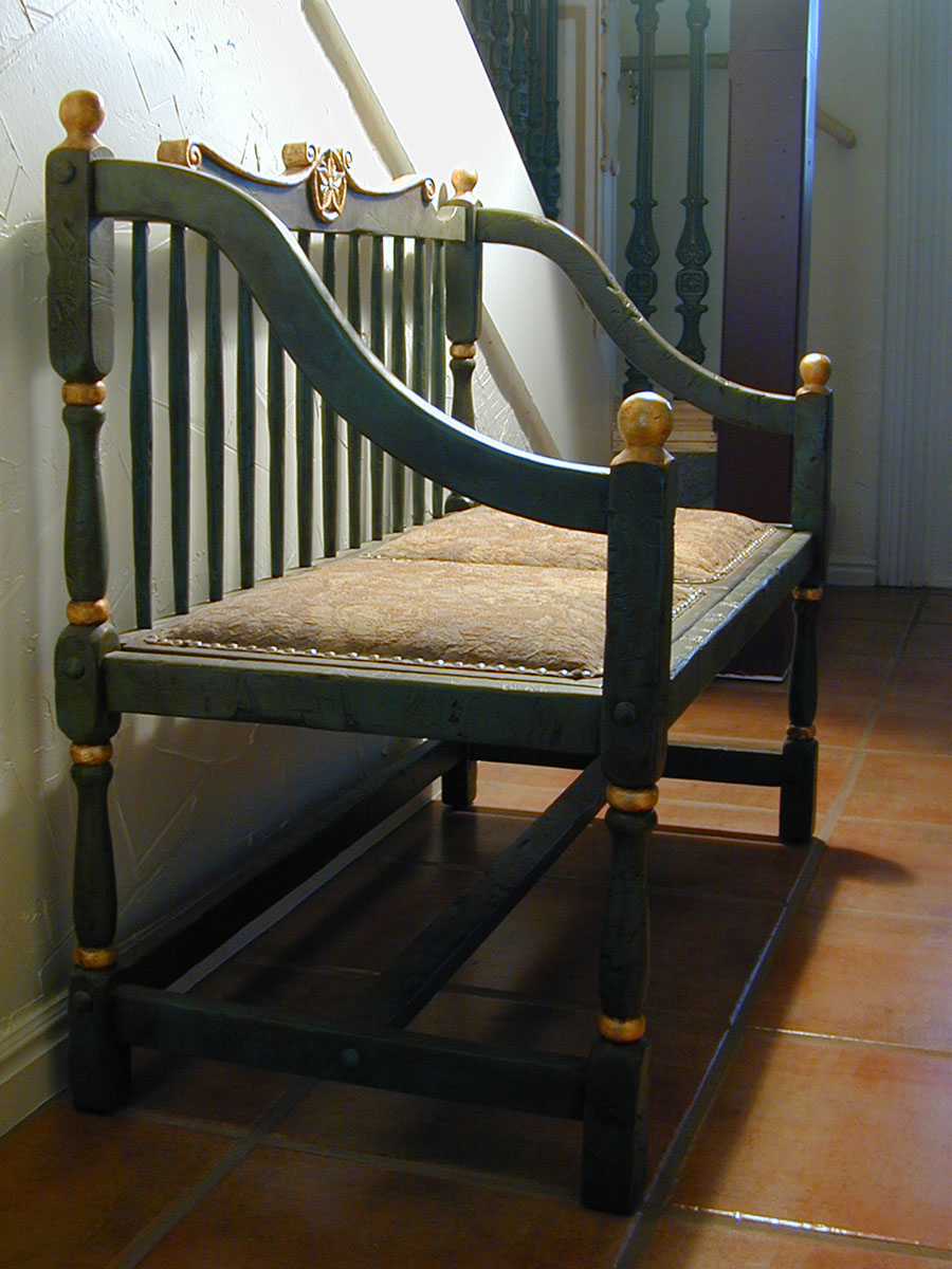 A remade settle for the entryway, hand-carved, gilded, and antiqued.