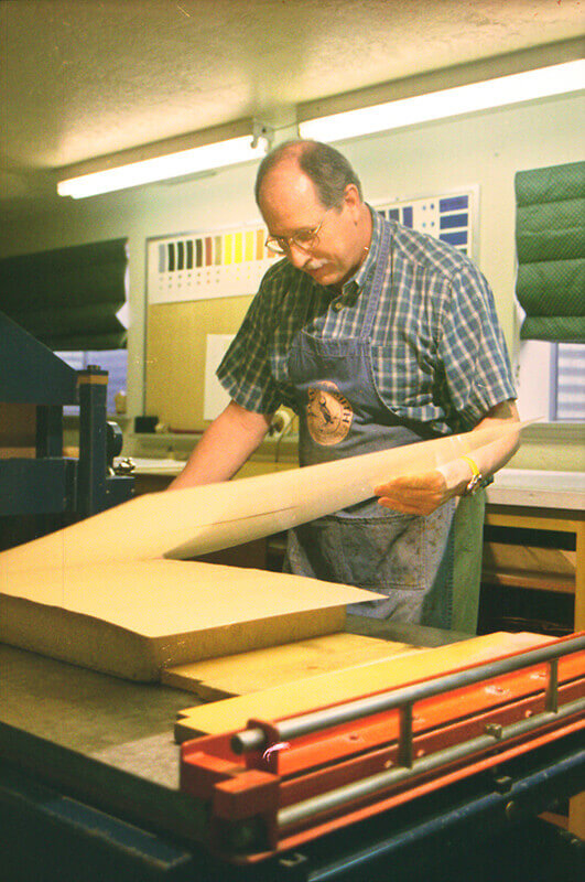 After the printing paper is in place on the stone, a sheet of newsprint is placed on top of it. ...