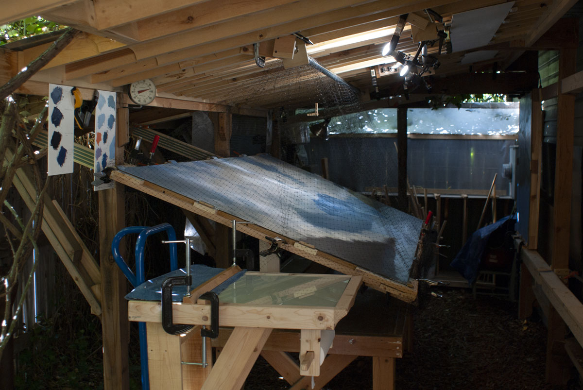 Looking southward along the drafting-table easel, the center panel of the triptych is mounted across...