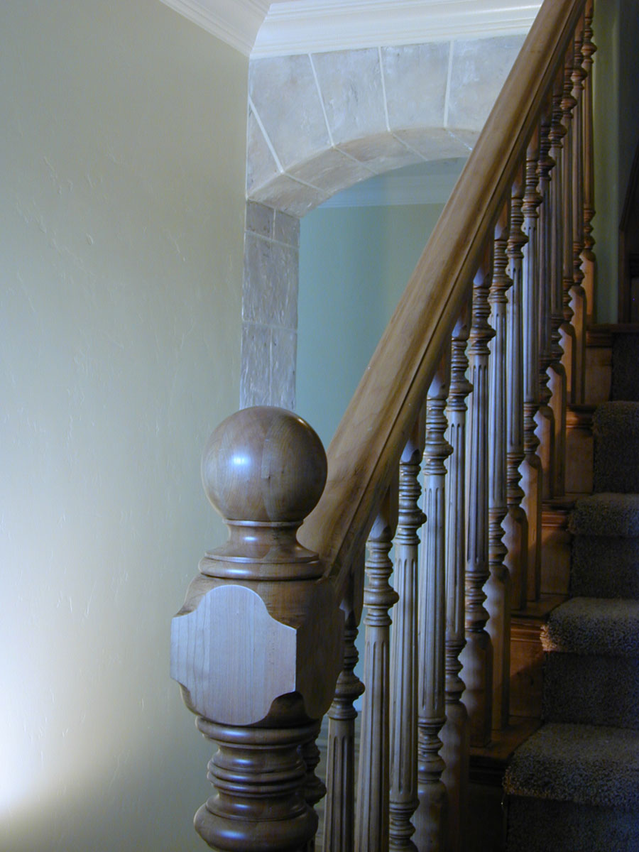 Another arch in the hall behind the fireplace.  Seen from an entryway, the glimpse of ston...