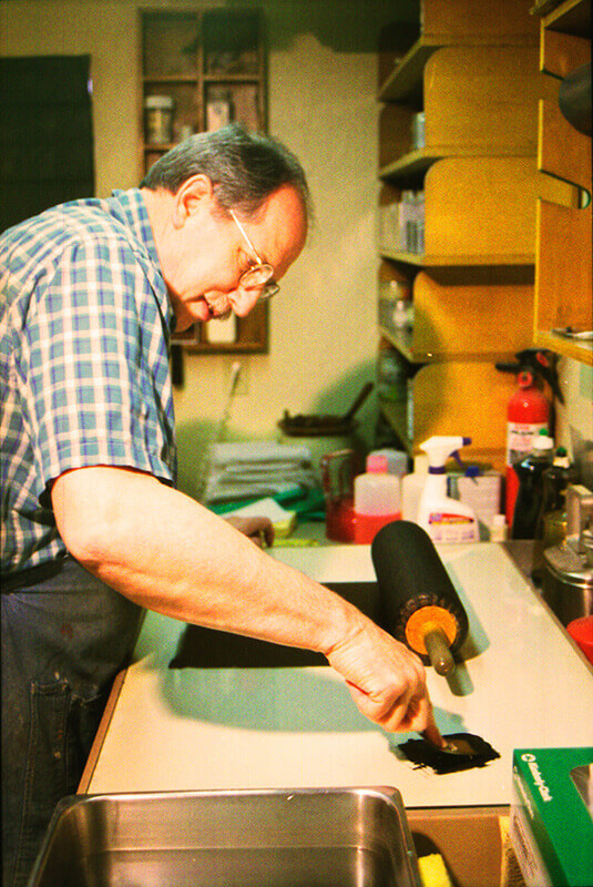 The leather roller is inked on the ink slab.  Three ribbons of ink are applied to the slab...