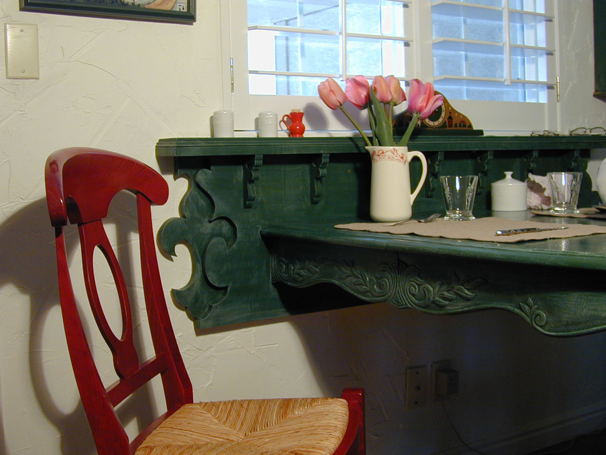 Al's design and fabrication of a wall-mounted breakfast table at the kitchen window.